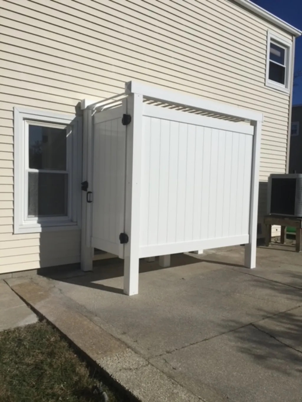 Outdoor shower behind garage
