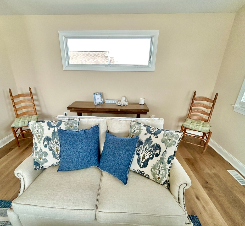 Table behind this love seat can be opened up easily and can be used to seat 4-6 more chairs.
