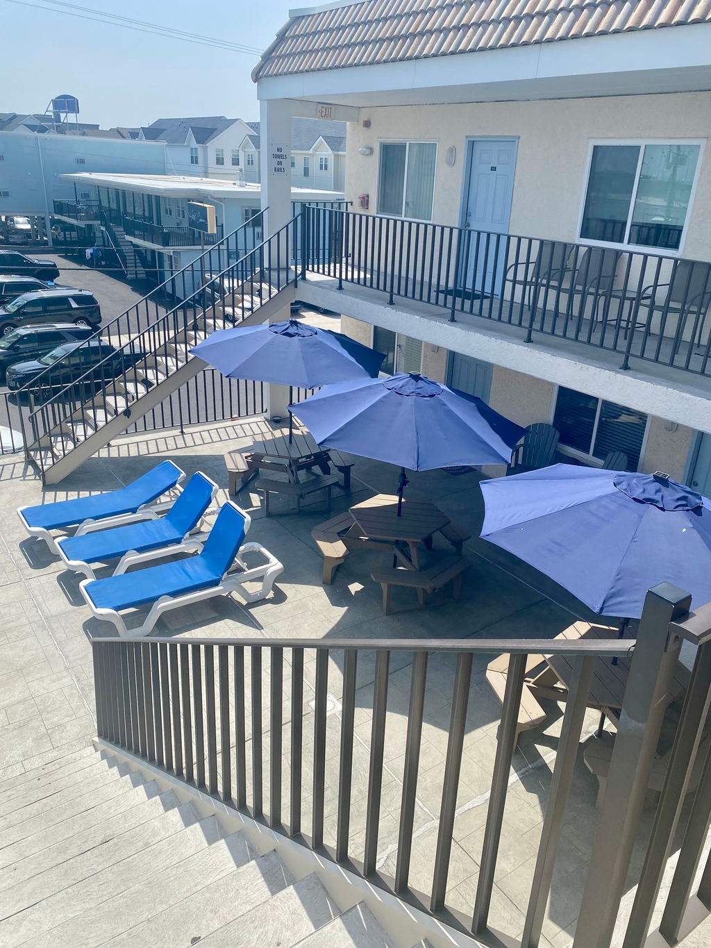 2nd floor sundeck with tables and Umbrellas