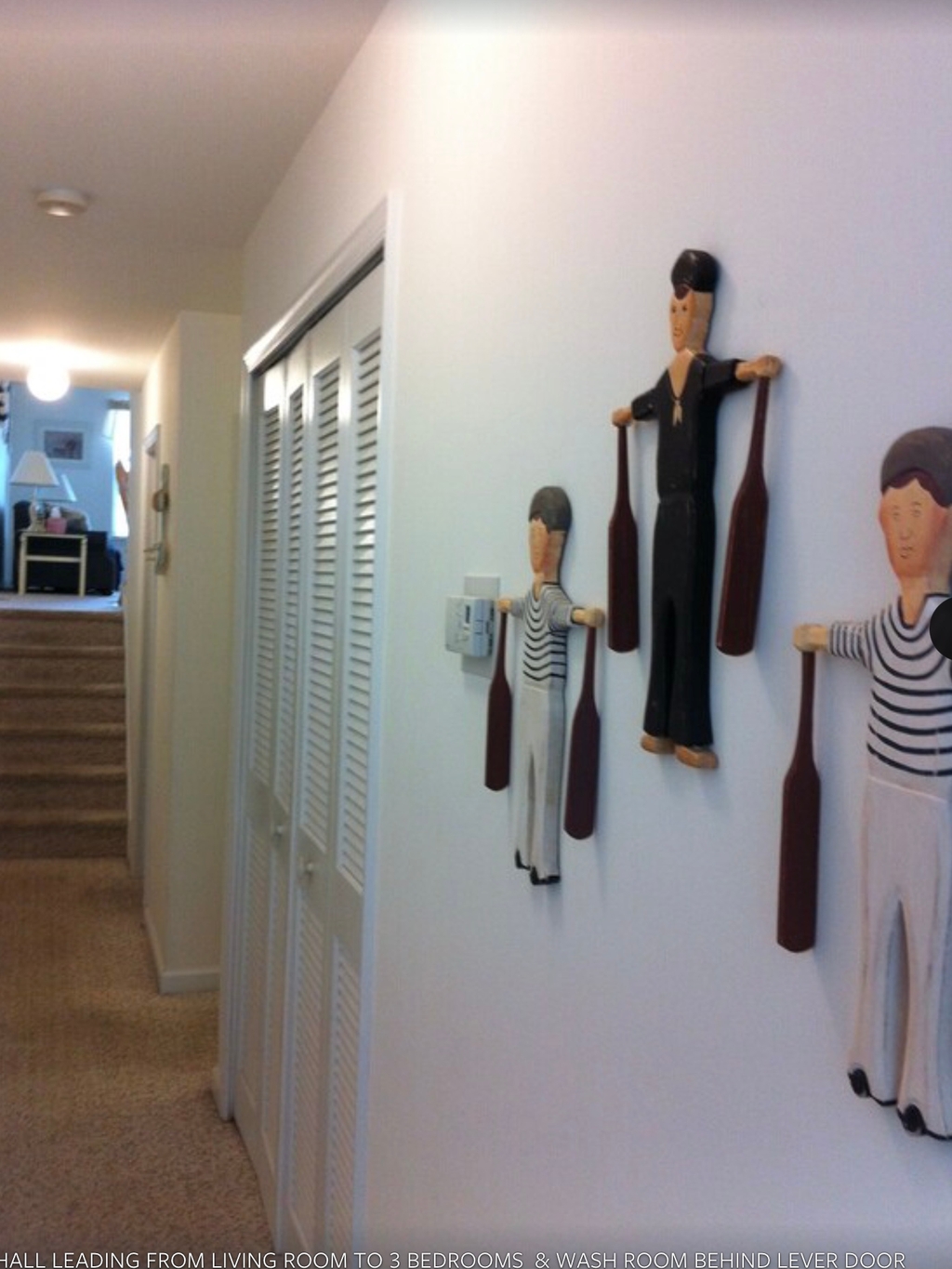 Hall leading to 3 bedrooms