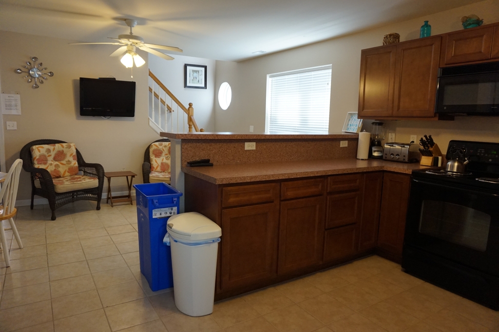 Kitchen to show TV and stairs to 2nd floor