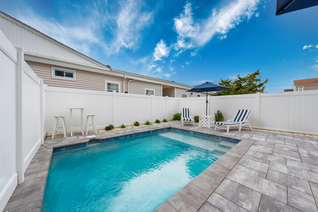 pool area: pub table, lounge chair and dining area