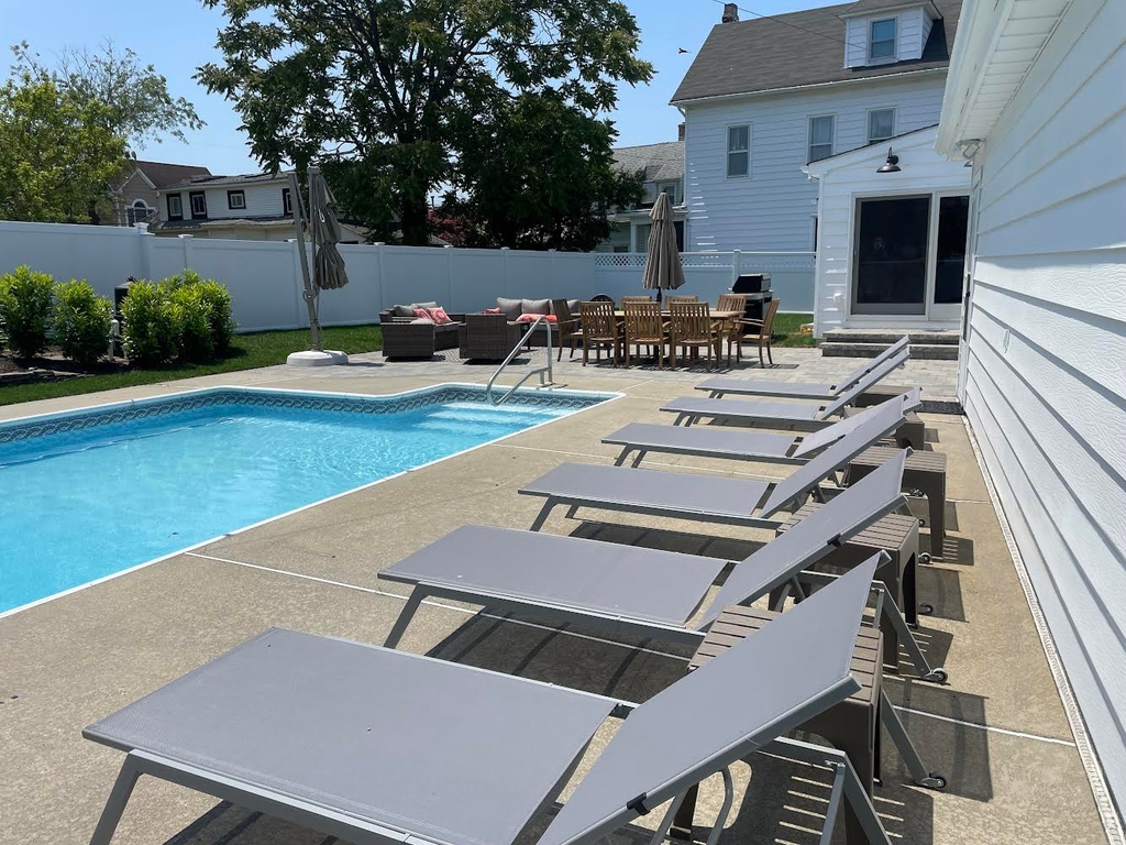 backyard pool, dining and lounge areas