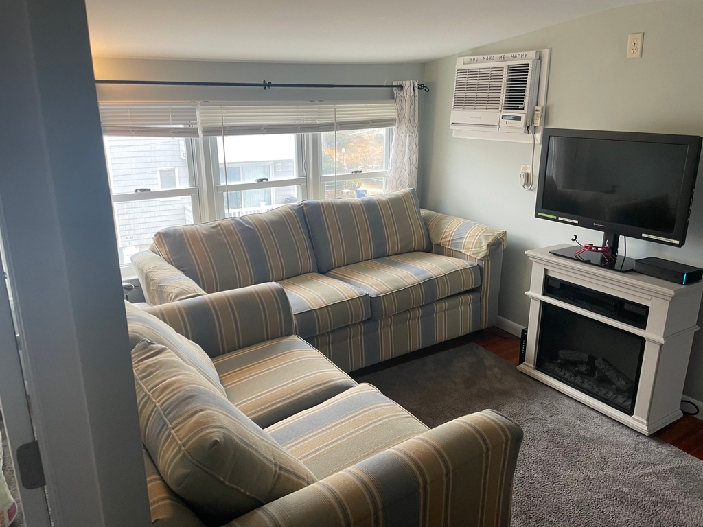 Living room with ocean views, fireplace and cable tv.