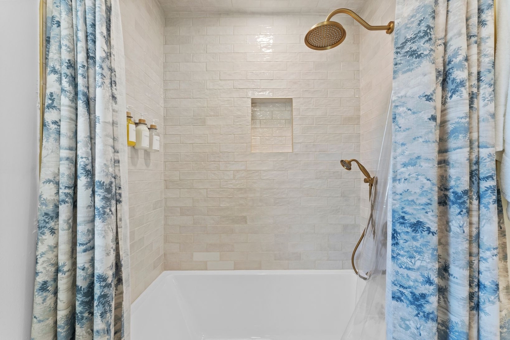 Full bathroom with bathtub and rain shower