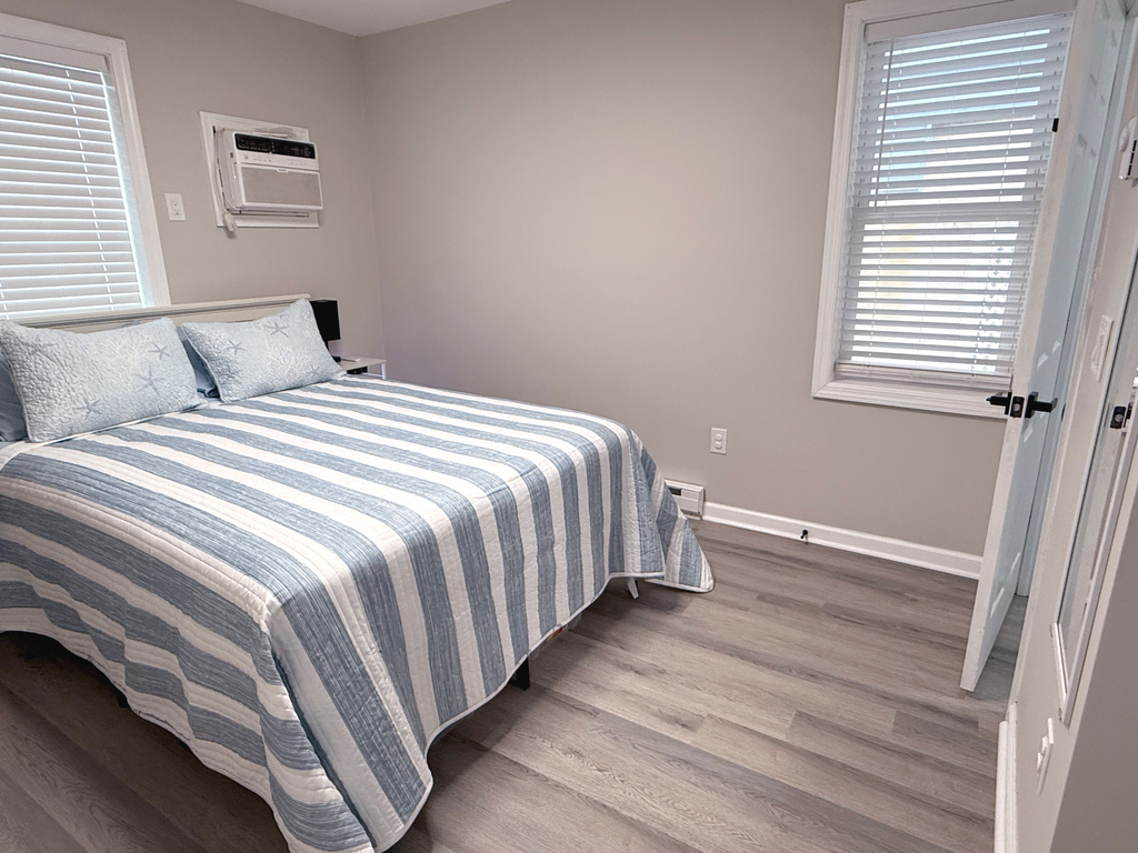 Second bedroom features queen bed and linens.
