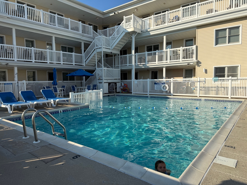 Heated pool with plenty of lounge and table seating