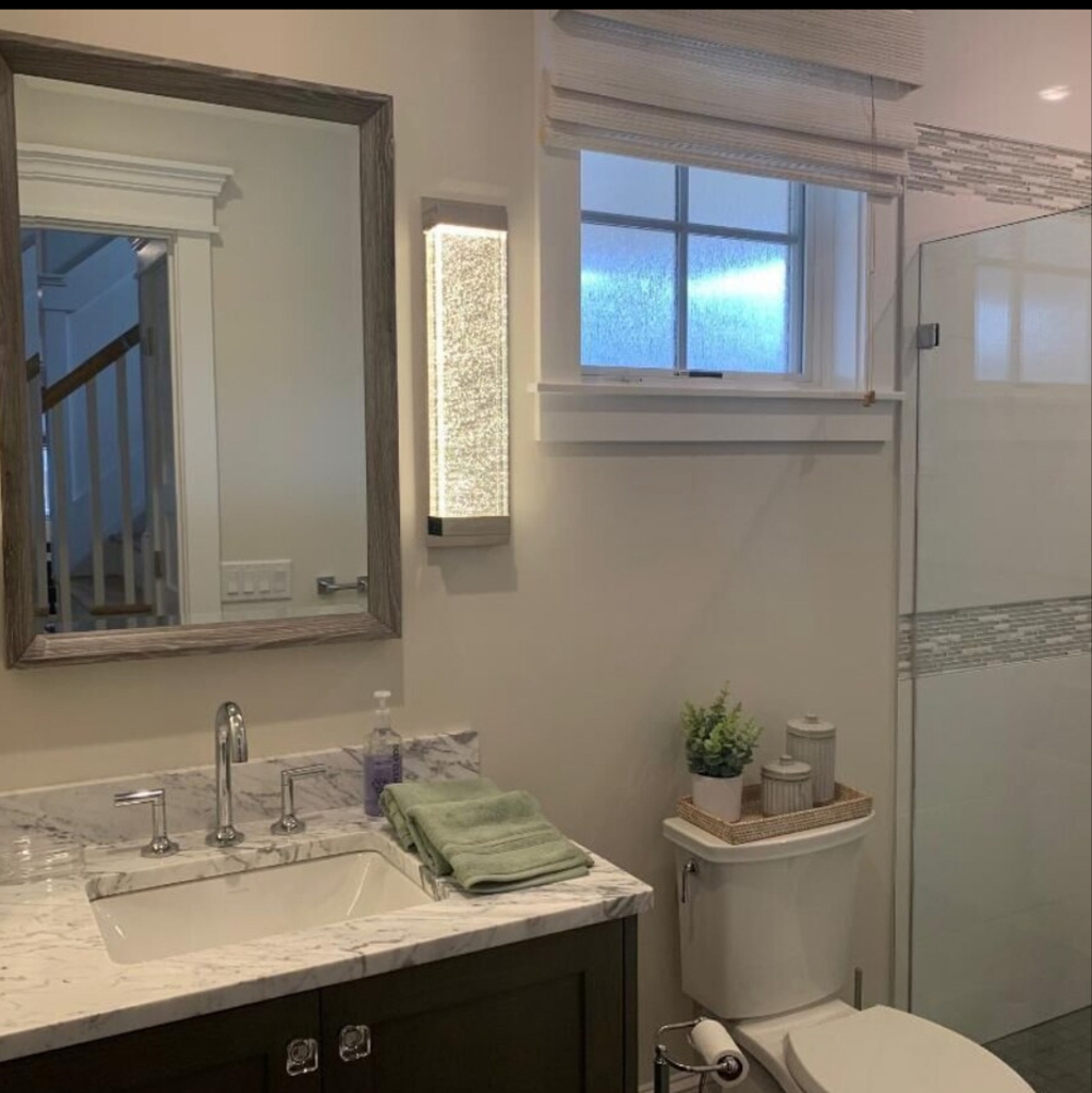 First floor powder room with shower across from Queen bedroome
