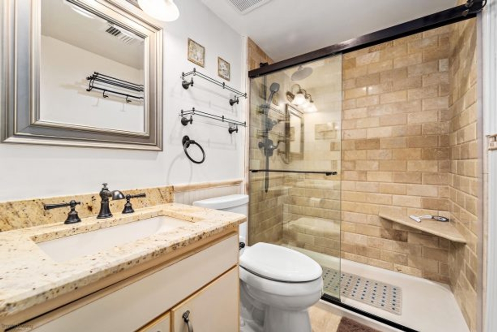 Tiled Bathroom w/Moen Polished Brass Fixtures