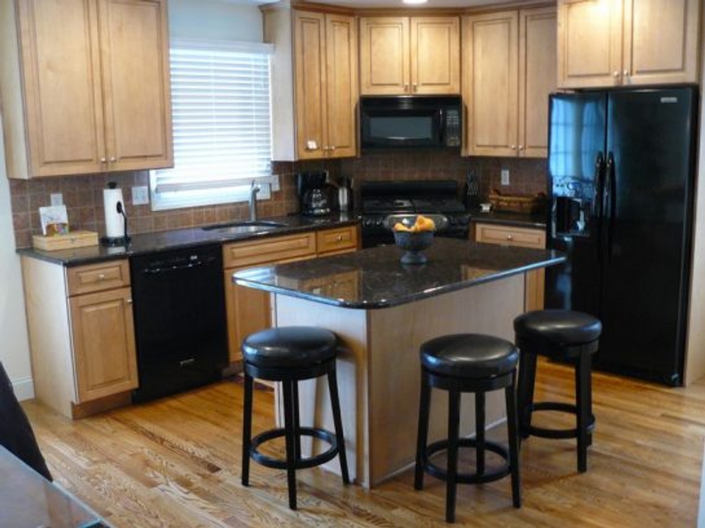 Gourmet Fully Outfitted Modern Kitchen with Sliders to Back Deck and Stairs to Backyard