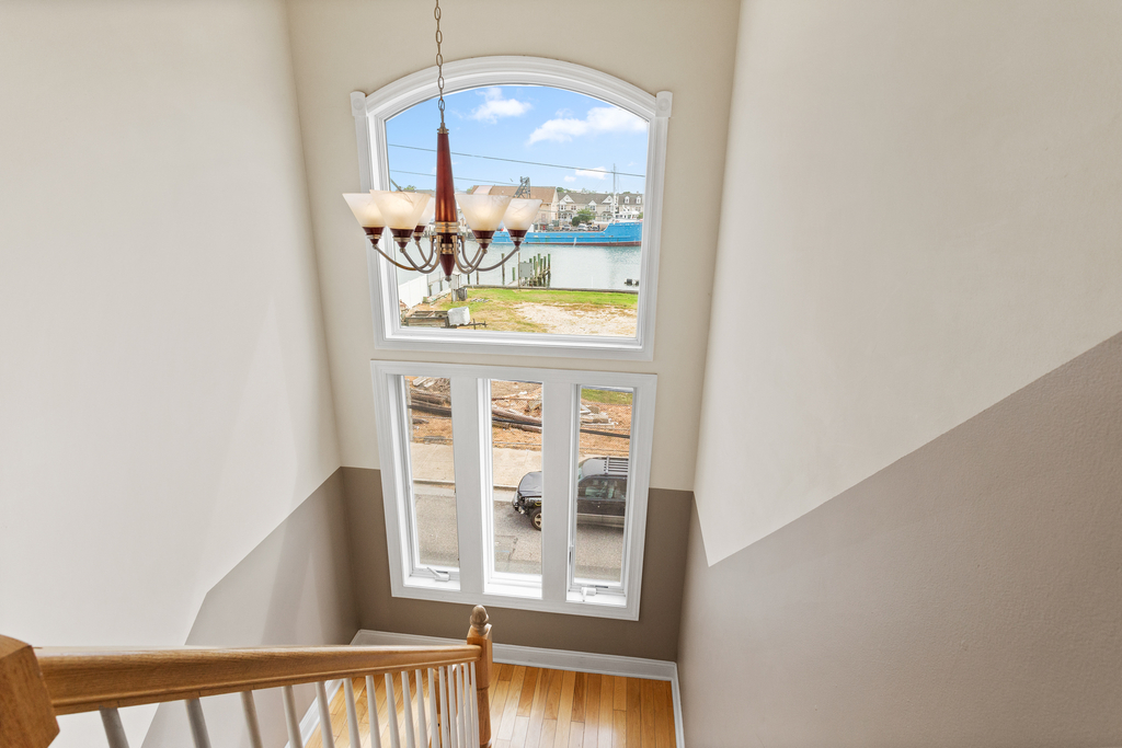 ❤️ The hallway starts at the Elevator and takes you to both Master Bedrooms and to a beautiful staircase on the other side with a unique chandelier and great water views! You will love it!