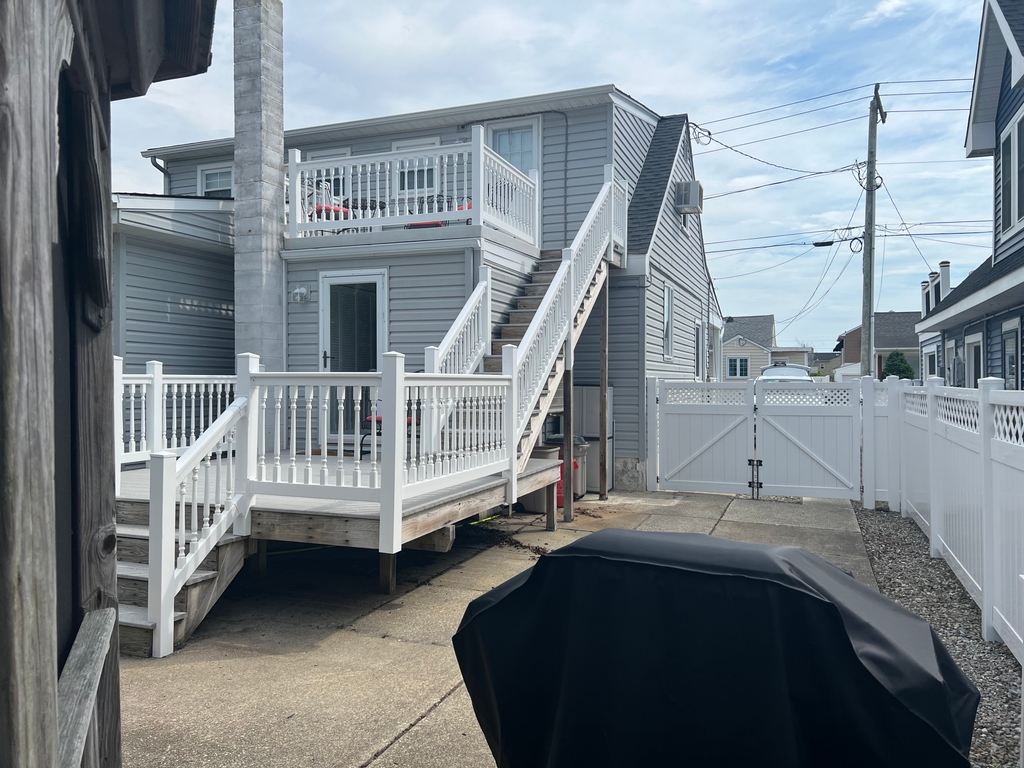 Back of the house has two decks and a second entrance for upstairs